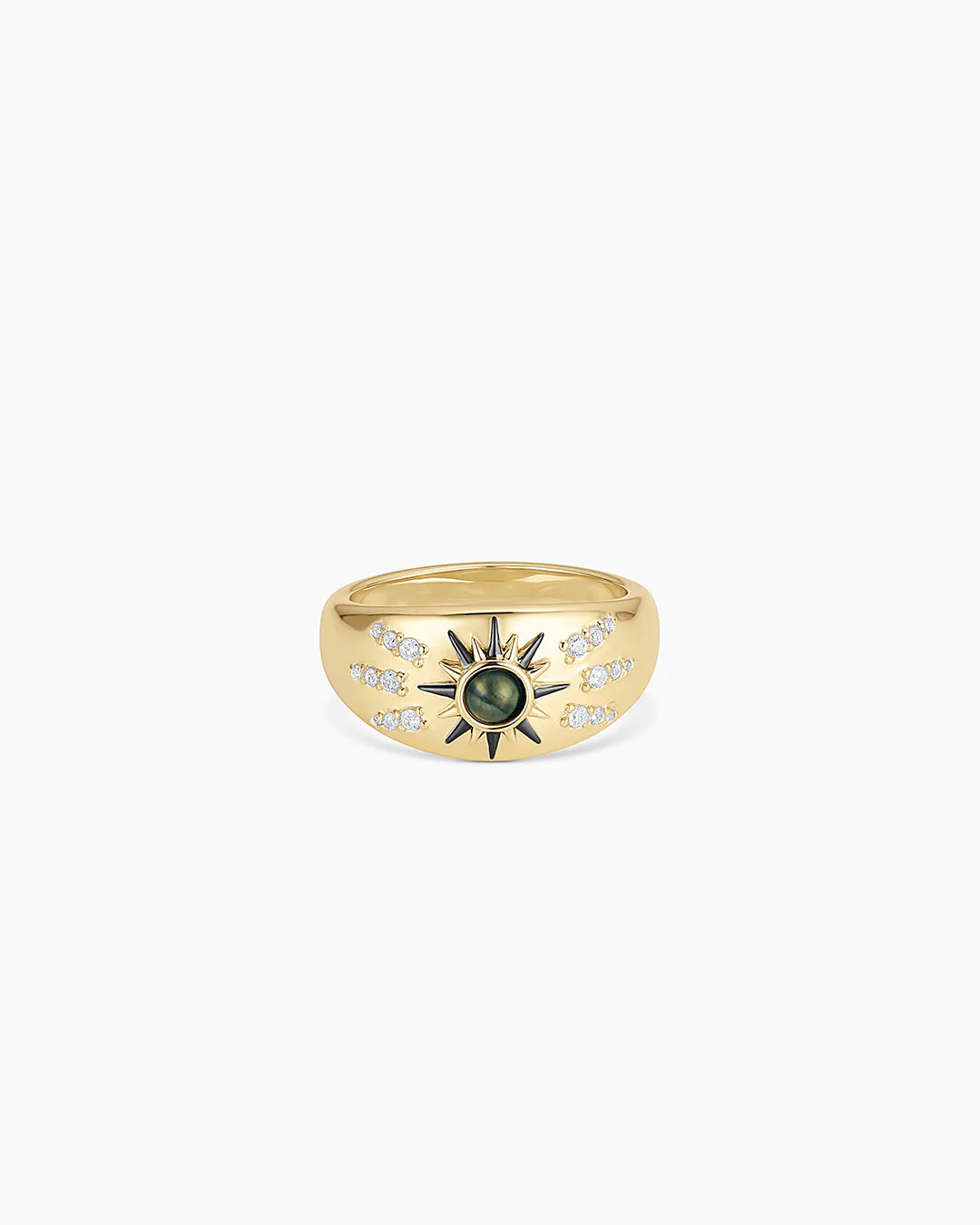 Gold statement ring featuring sunburst design with green gemstone center.