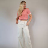 Pink cropped sweater top with short sleeves and a Johnny collar, offering a chic and relaxed style.
