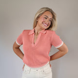 Cropped pink sweater top featuring short sleeves and a Johnny collar design for a modern, casual look.