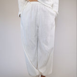 Casual white linen Divinia pants by Steve Madden with a flowy wide-leg fit, side pockets, and a drawstring elastic waistband.
