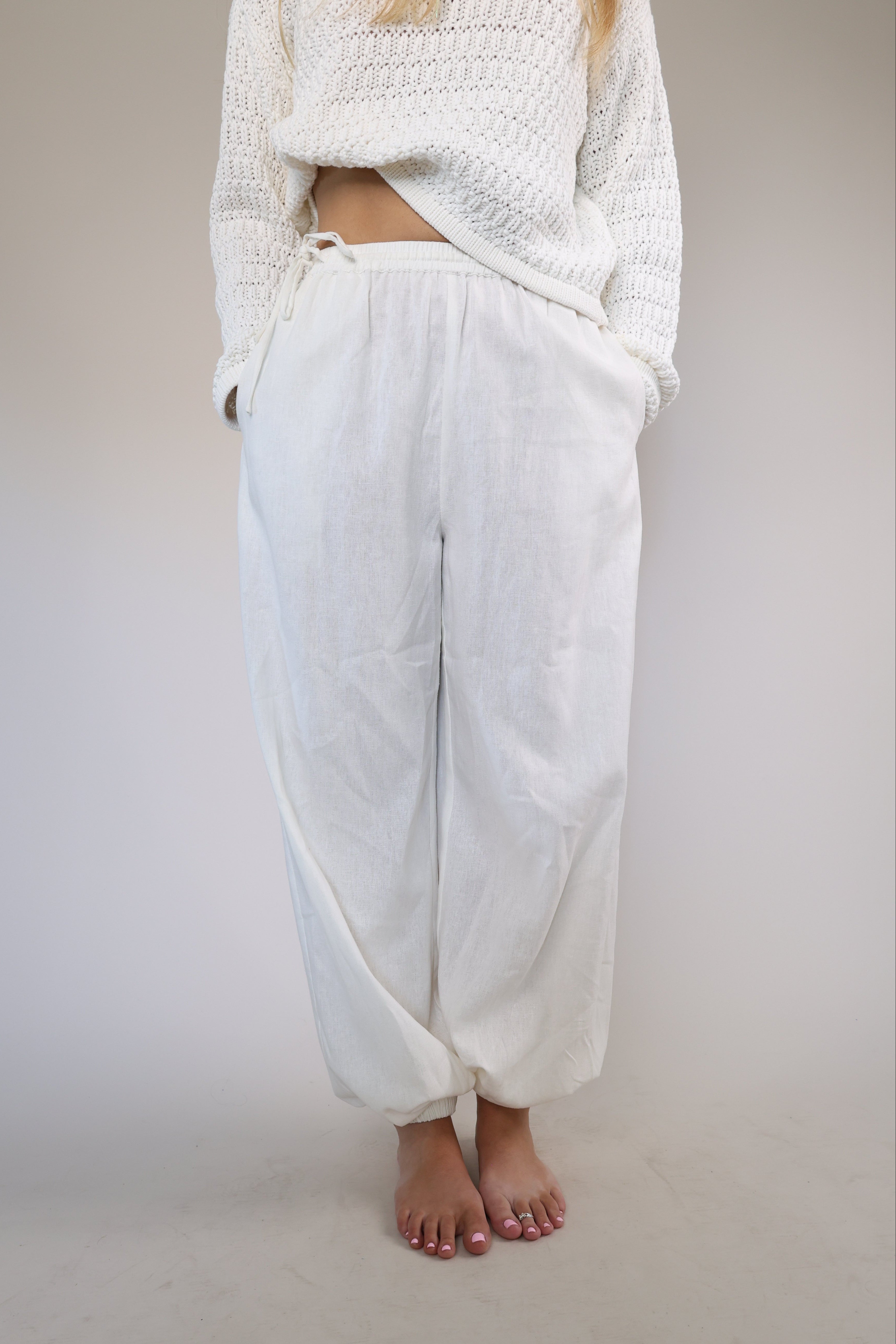 Casual white linen Divinia pants by Steve Madden with a flowy wide-leg fit, side pockets, and a drawstring elastic waistband.