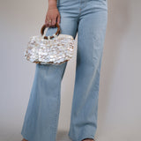 Wide-leg denim jeans with a high-rise fit and raw edge hem detailing.