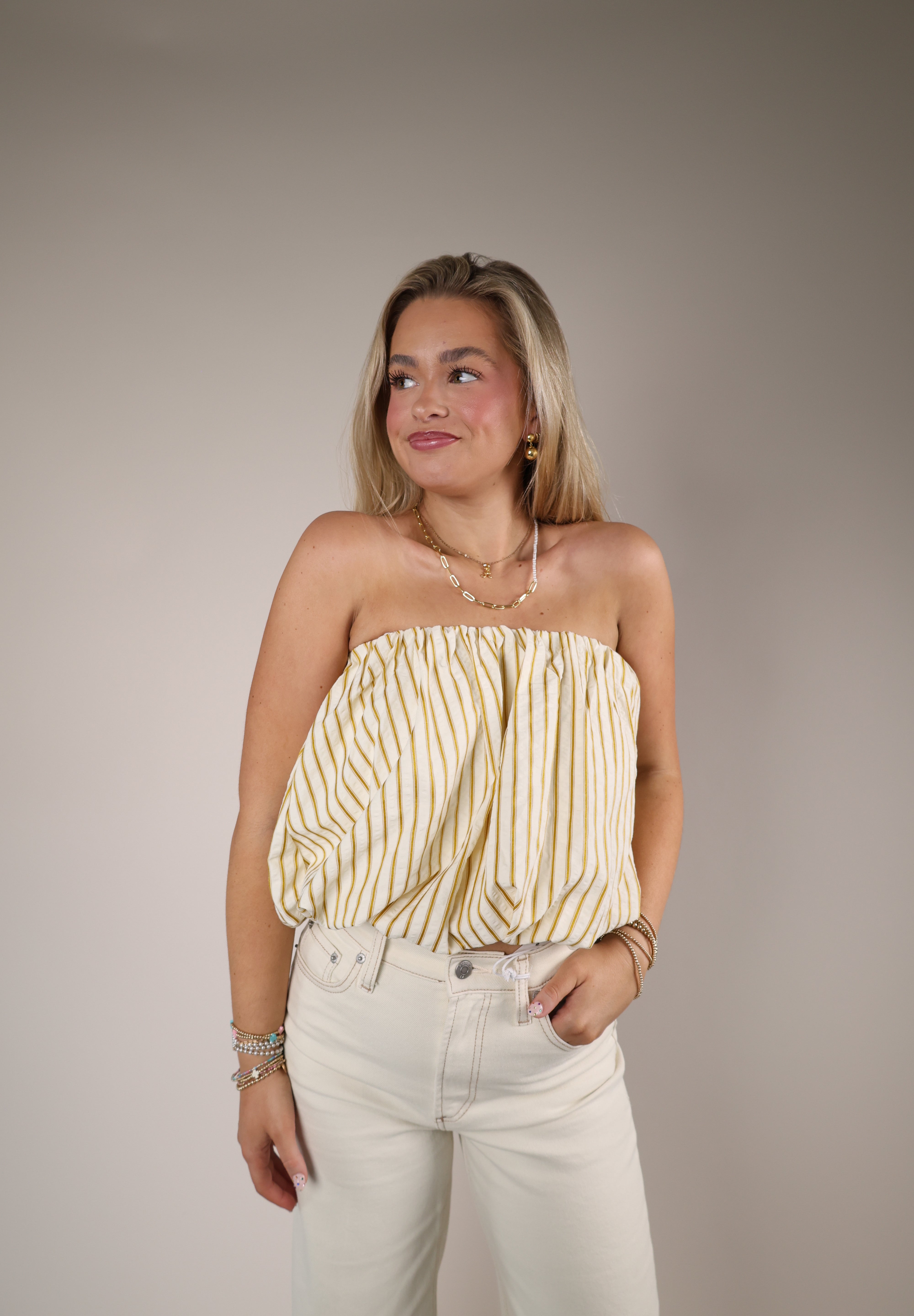 Women’s yellow striped strapless top Shear Boutique spring collection 2026 bubble hem top breezy warm weather look