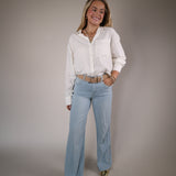 Shear Boutique spring 2026 white blouse relaxed button up shirt versatile layering piece everyday style