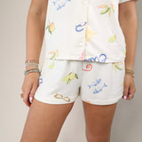 Z Supply Tropic PJ shorts in cream with colorful tropical print and elastic waistband.