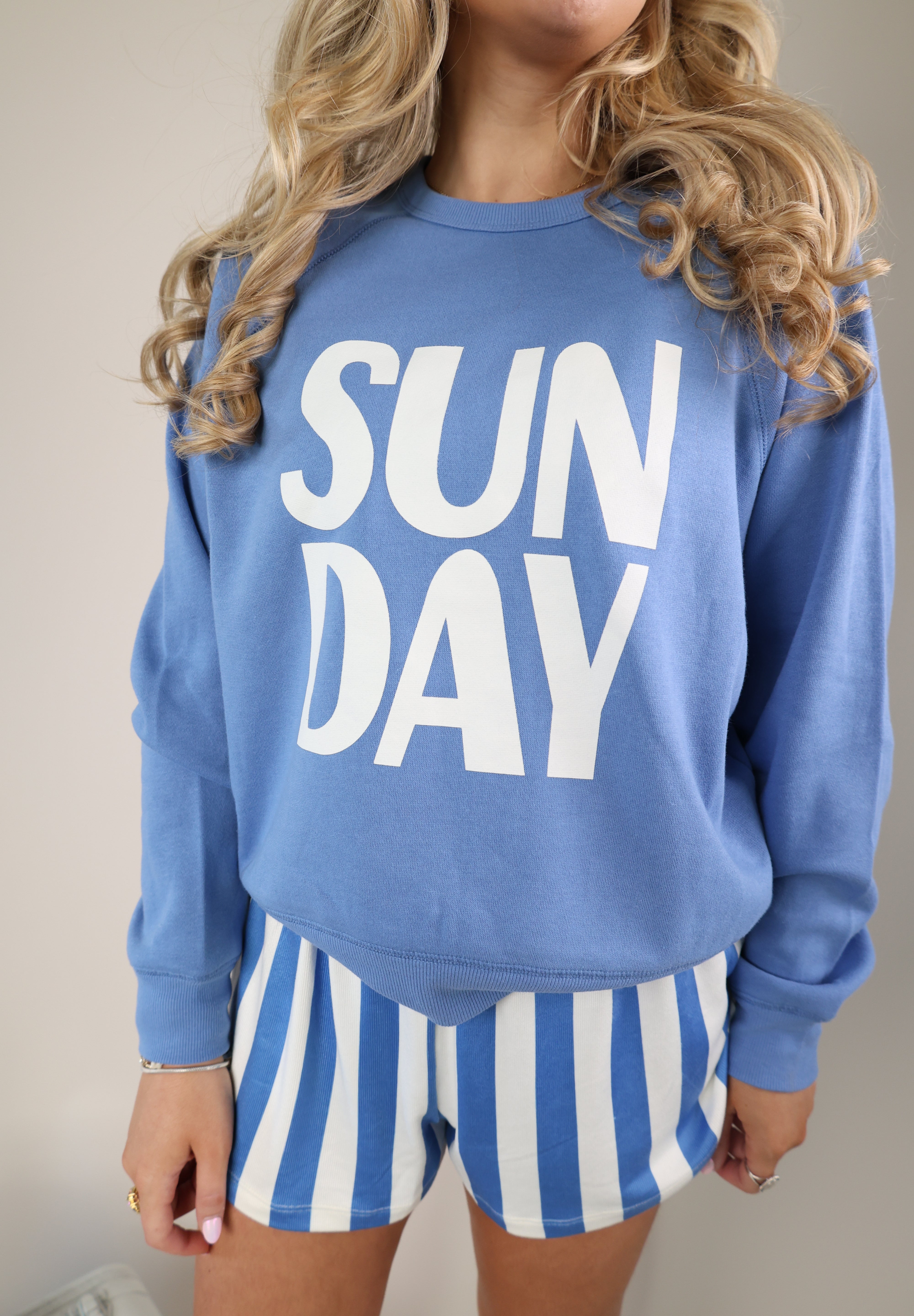 Relaxed Z Supply Sunday sweatshirt in blue with playful white lettering and cozy crewneck style.
