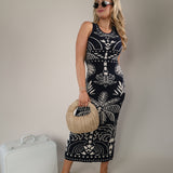 Z Supply Esperanza midi dress in navy with cream tropical palm pattern and sleeveless fitted silhouette.