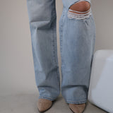 Women’s Pistola Hendrix Baggy Fix jeans in faded blue denim with a loose fit and knee rip.