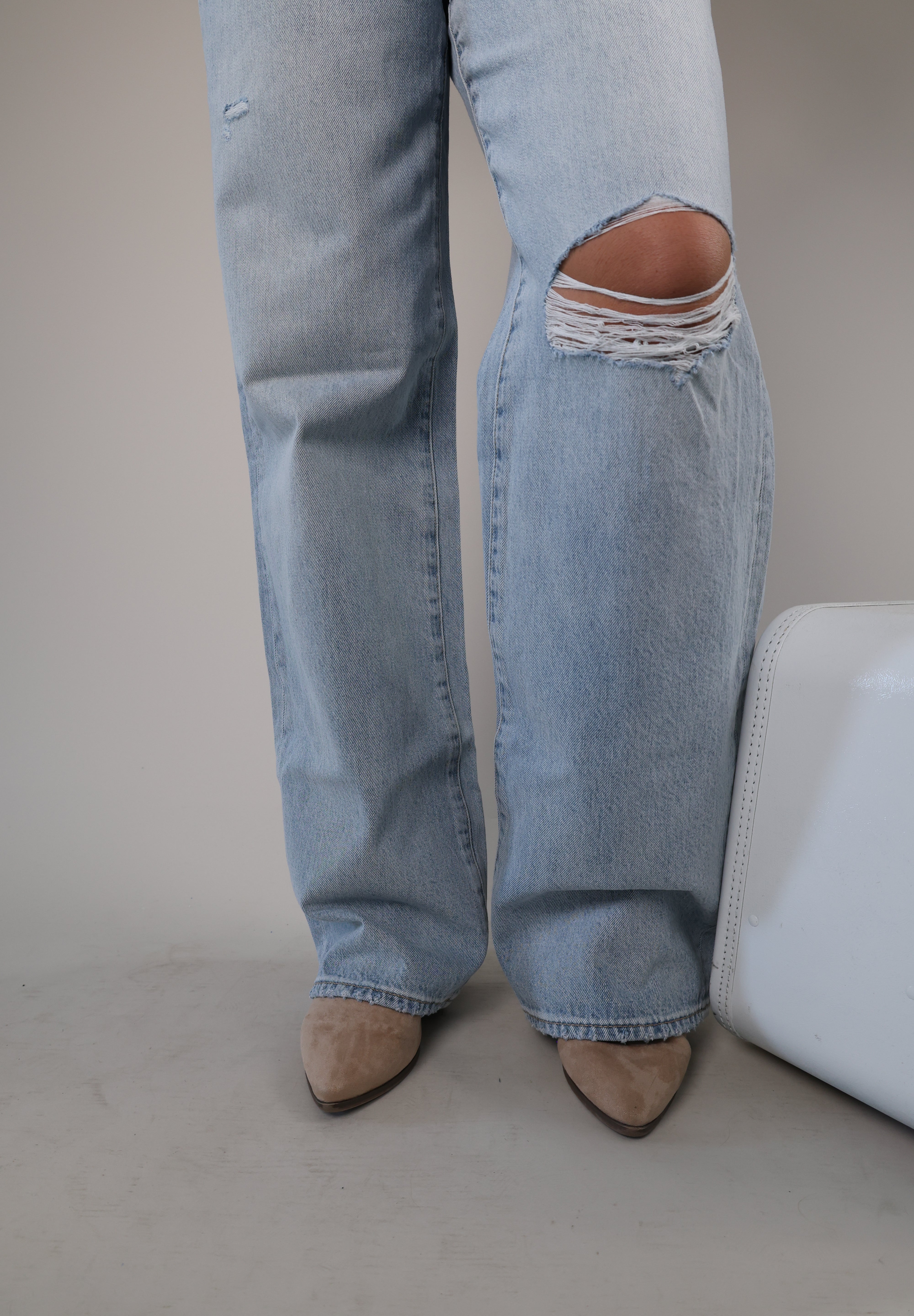 Women’s Pistola Hendrix Baggy Fix jeans in faded blue denim with a loose fit and knee rip.