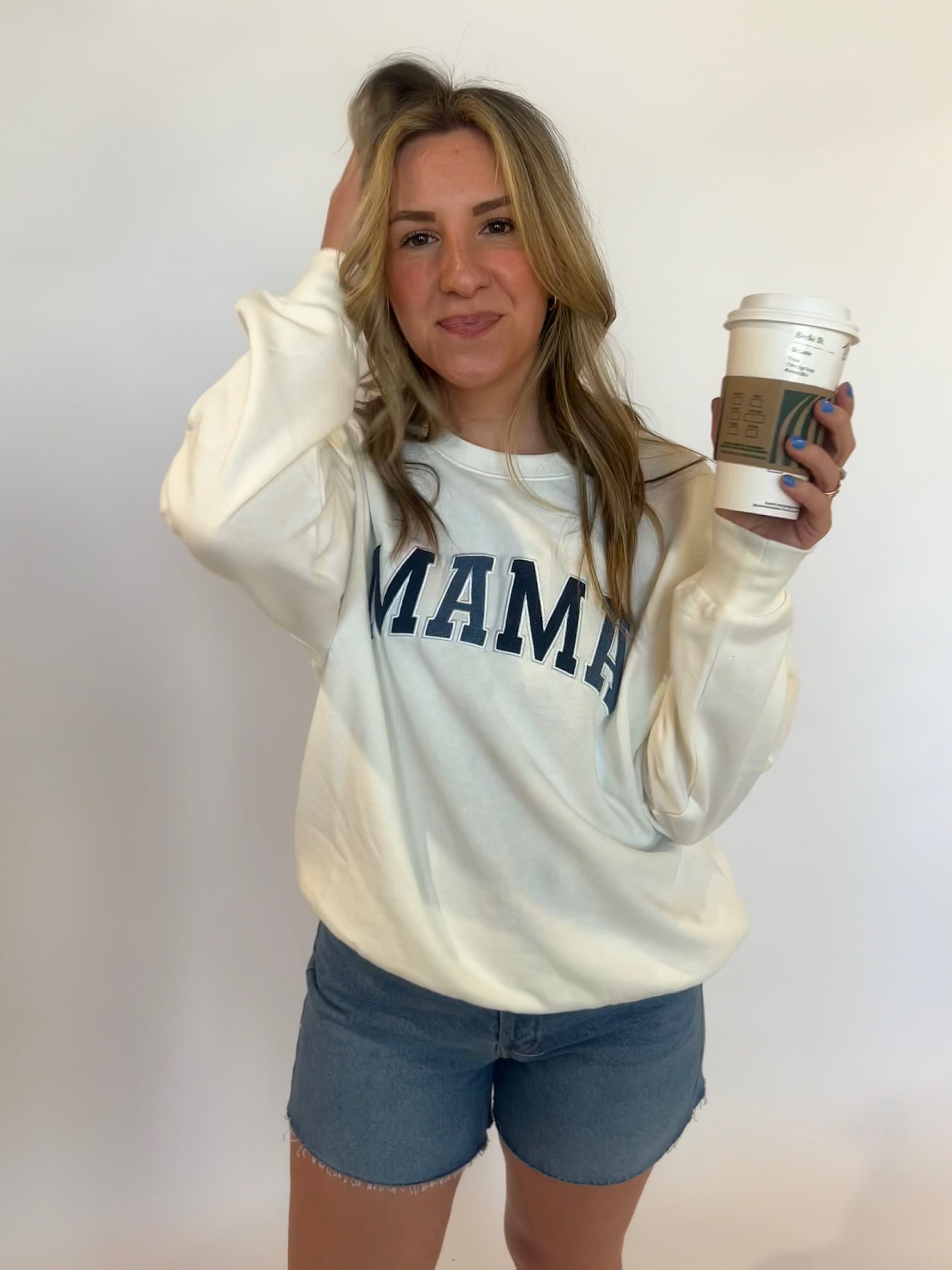 Woman holding coffee cup and wearing the product