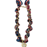 Gemelli Carson Scarf Chain Necklace featuring an 18k gold-plated chain with a silky red and blue patterned scarf, and a gold heart medallion. 