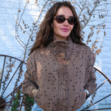 Chic brown cropped jacket styled with denim for an elevated everyday fall look