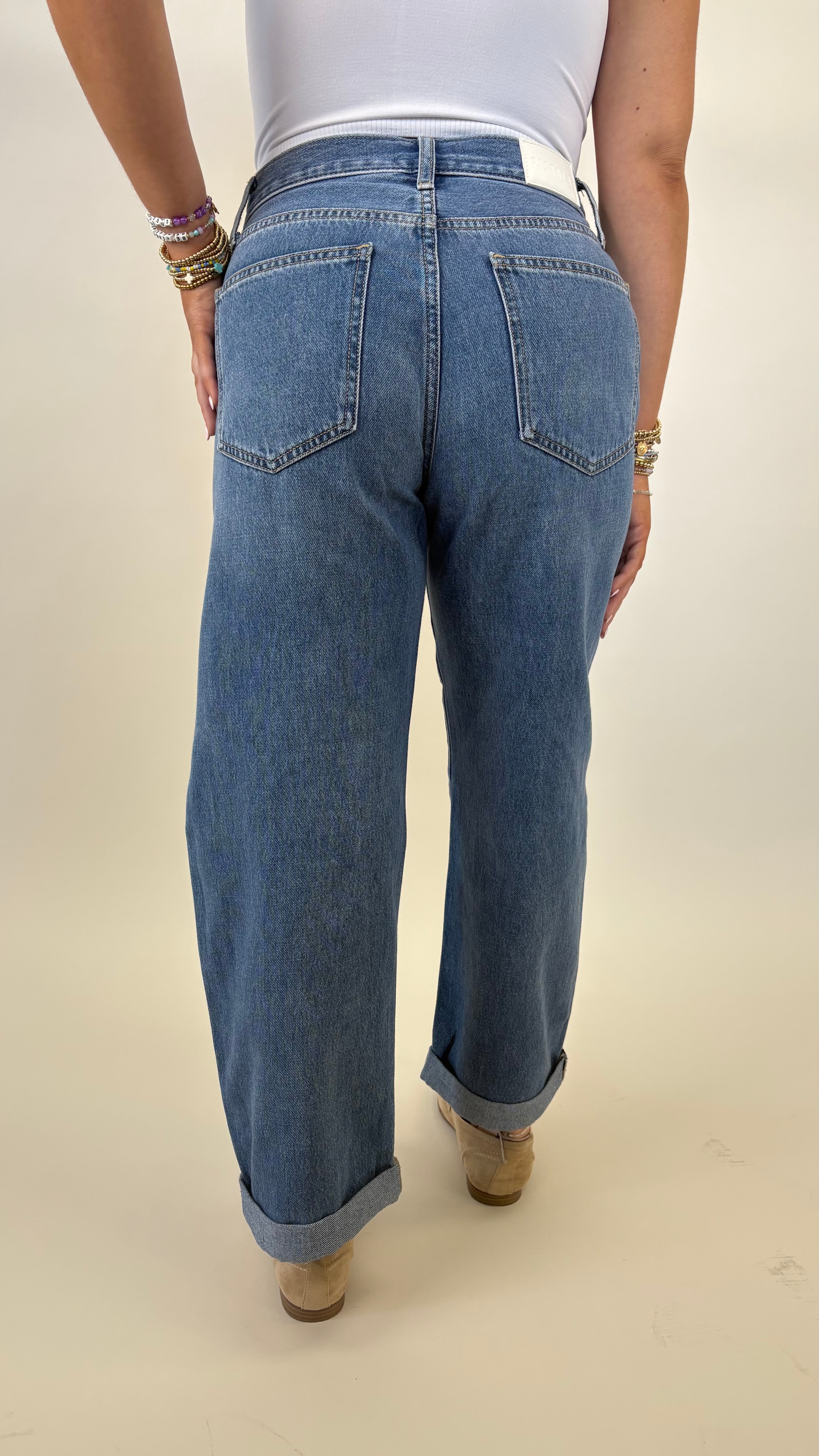 High rise Pistola Donny jeans featuring bowed wide leg silhouette and rolled cuff
