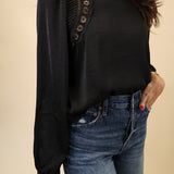 Chic black embroidered blouse by Z Supply showcasing a mock neck, scalloped edges, and classic long sleeves.