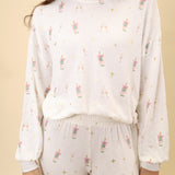 Soft long-sleeve crewneck top featuring an allover champagne toast print and an easy, relaxed silhouette.