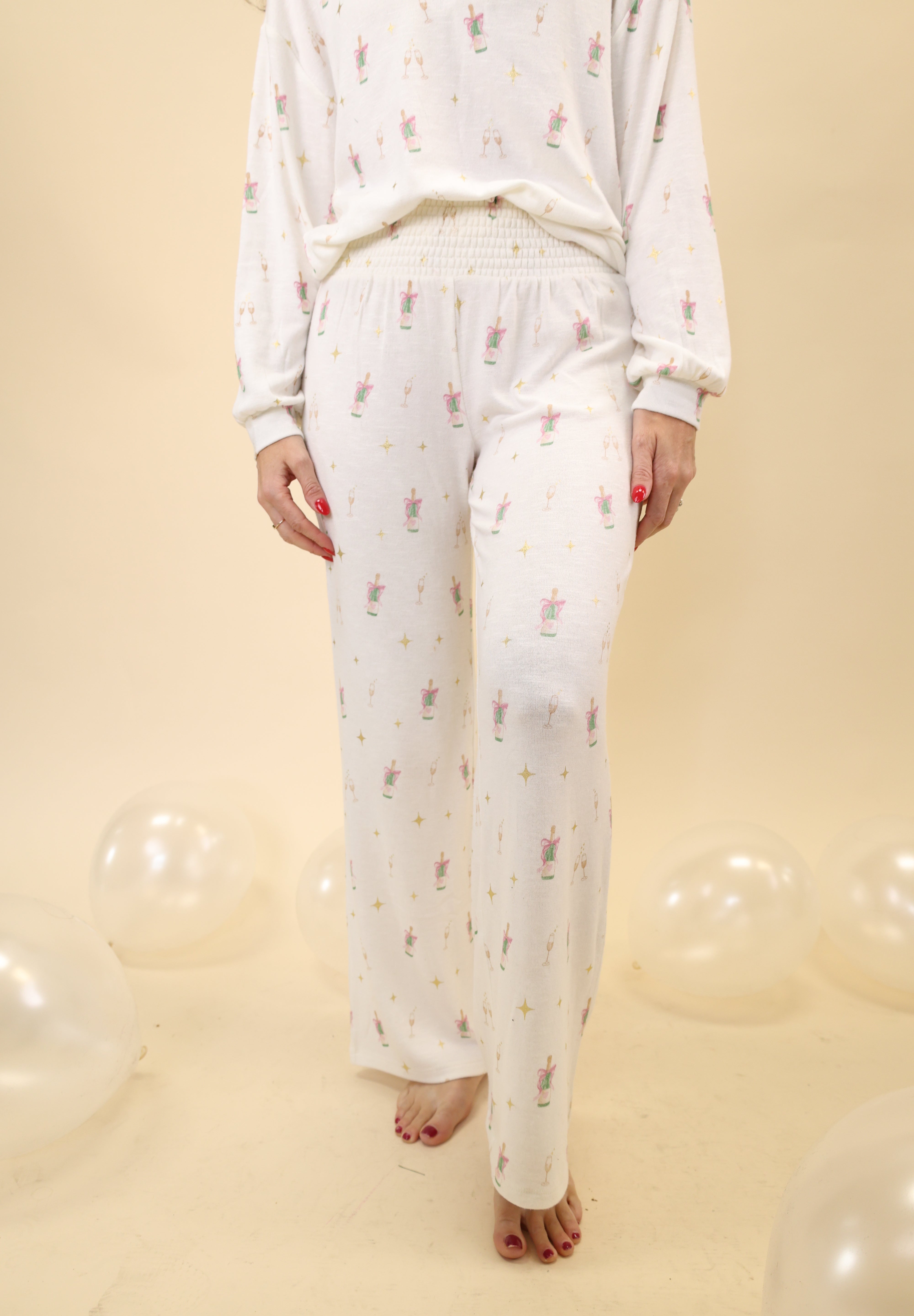 Z Supply Dawn Champs Pants with a soft feel, smocked waistband, high-rise fit, and full-length fit-and-flare silhouette.