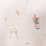 Relaxed-fit crewneck top decorated with an allover champagne toast motif, crafted from soft, comfortable fabric.