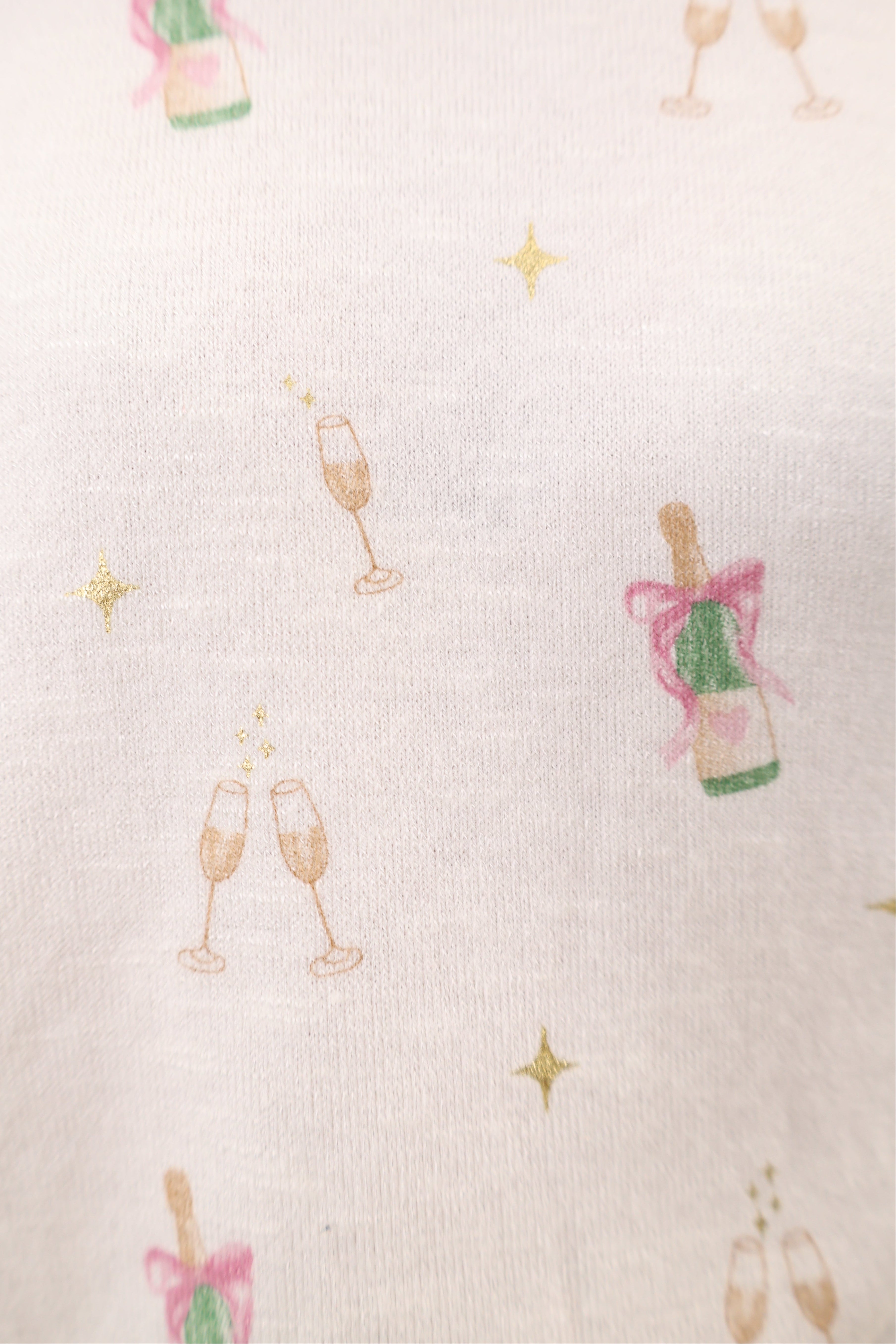 Relaxed-fit crewneck top decorated with an allover champagne toast motif, crafted from soft, comfortable fabric.