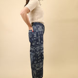 Curved barrel-leg pants in a navy bandana print, designed with a mid to high rise waist.