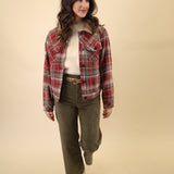 Owen Trucker Jacket in red plaid featuring sherpa lining, button front, long sleeves, welt pockets, and structured waistband and cuffs.