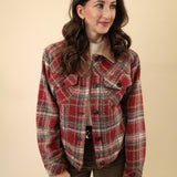 Red plaid sherpa-lined trucker jacket featuring a classic button front, long sleeves, welt pockets, and structured cuffs and waistband.