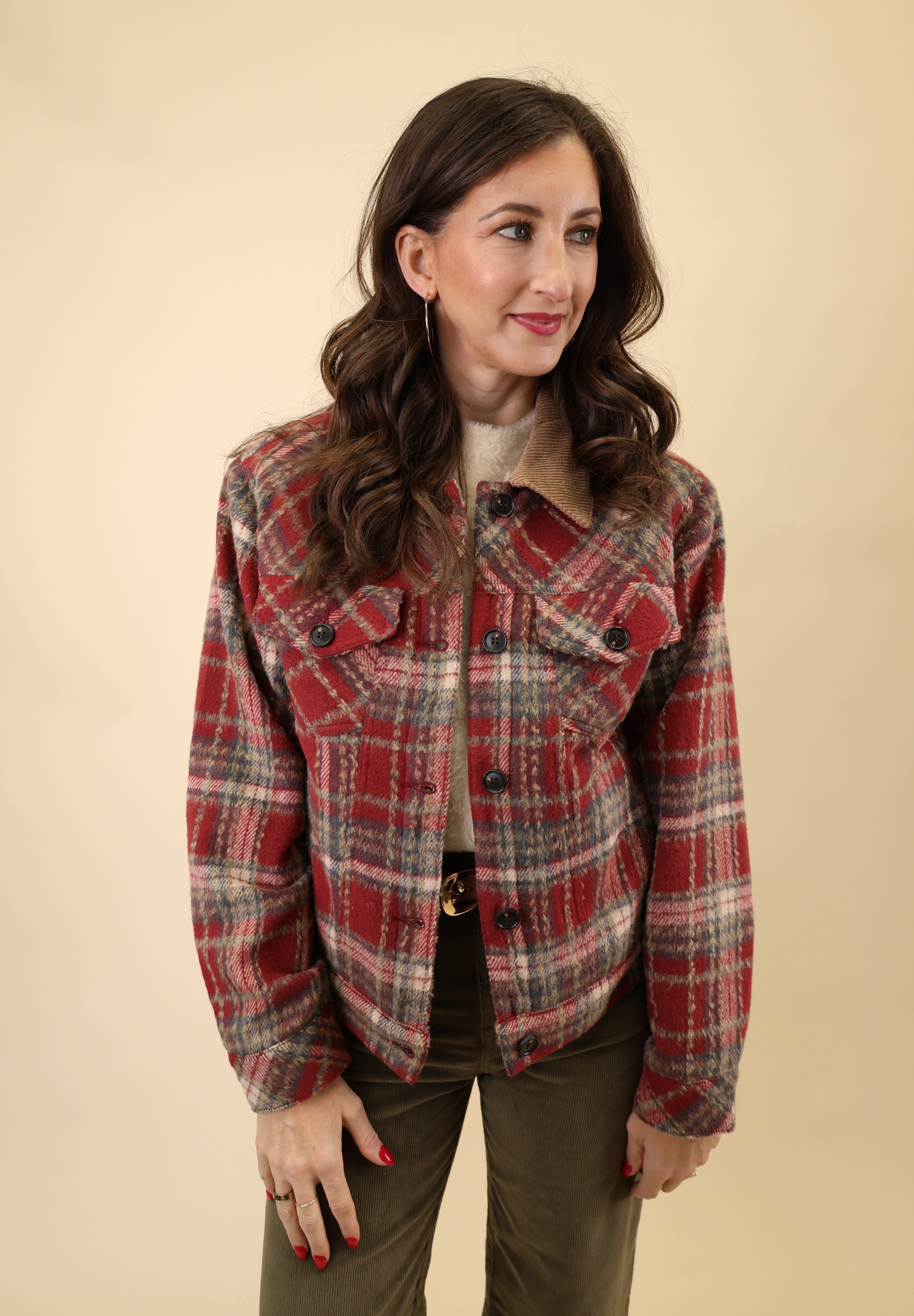 Red plaid sherpa-lined trucker jacket featuring a classic button front, long sleeves, welt pockets, and structured cuffs and waistband.