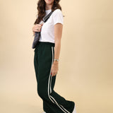 Flattering green Saunder track pant by Z Supply with a light, flowy drape, high-rise design, and white stripes at the side seams.