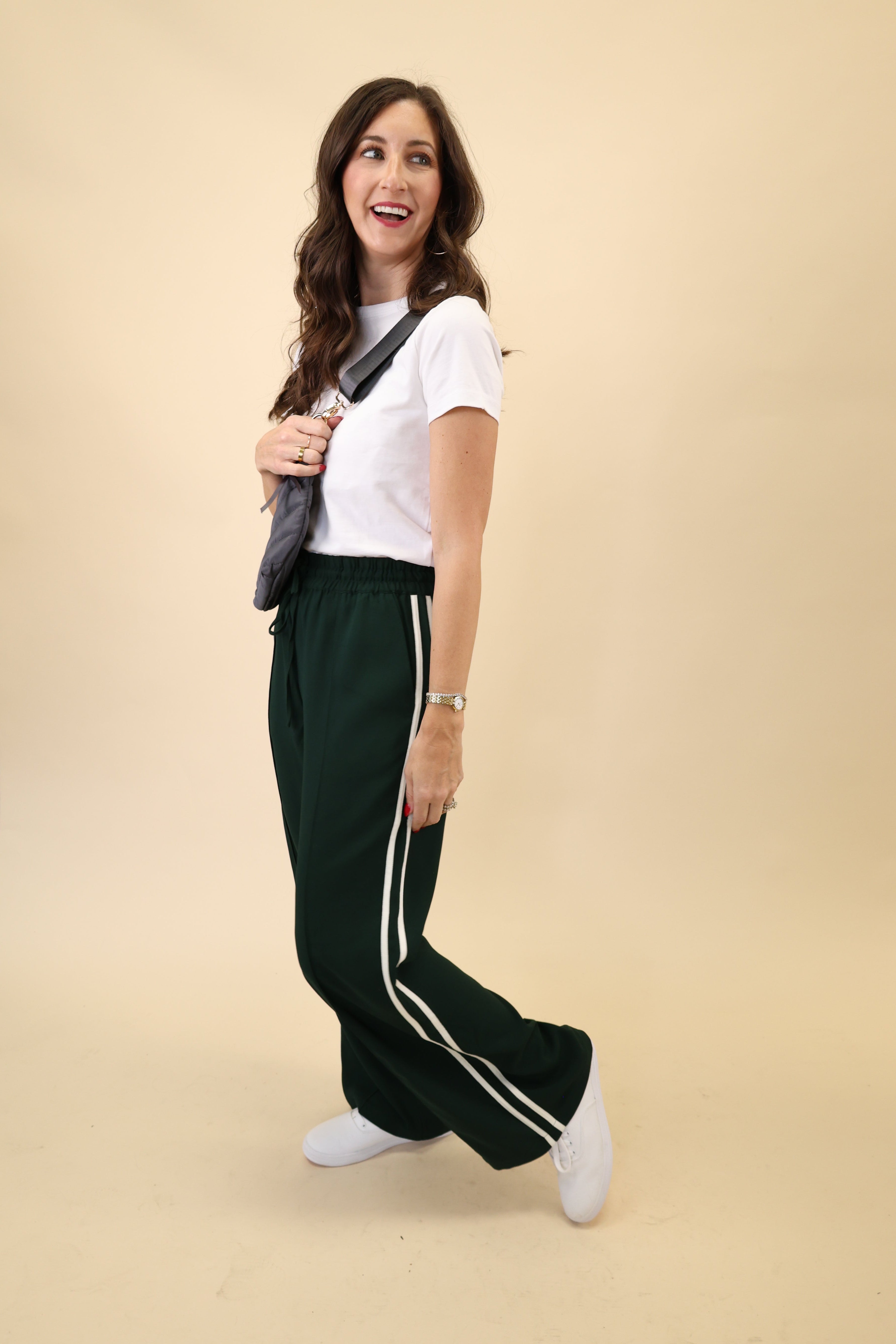 Flattering green Saunder track pant by Z Supply with a light, flowy drape, high-rise design, and white stripes at the side seams.