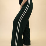 Light green Z Supply Saunder Track Pant with a flowy wide-leg fit, high-rise waist, and white stripe detailing along the seams.