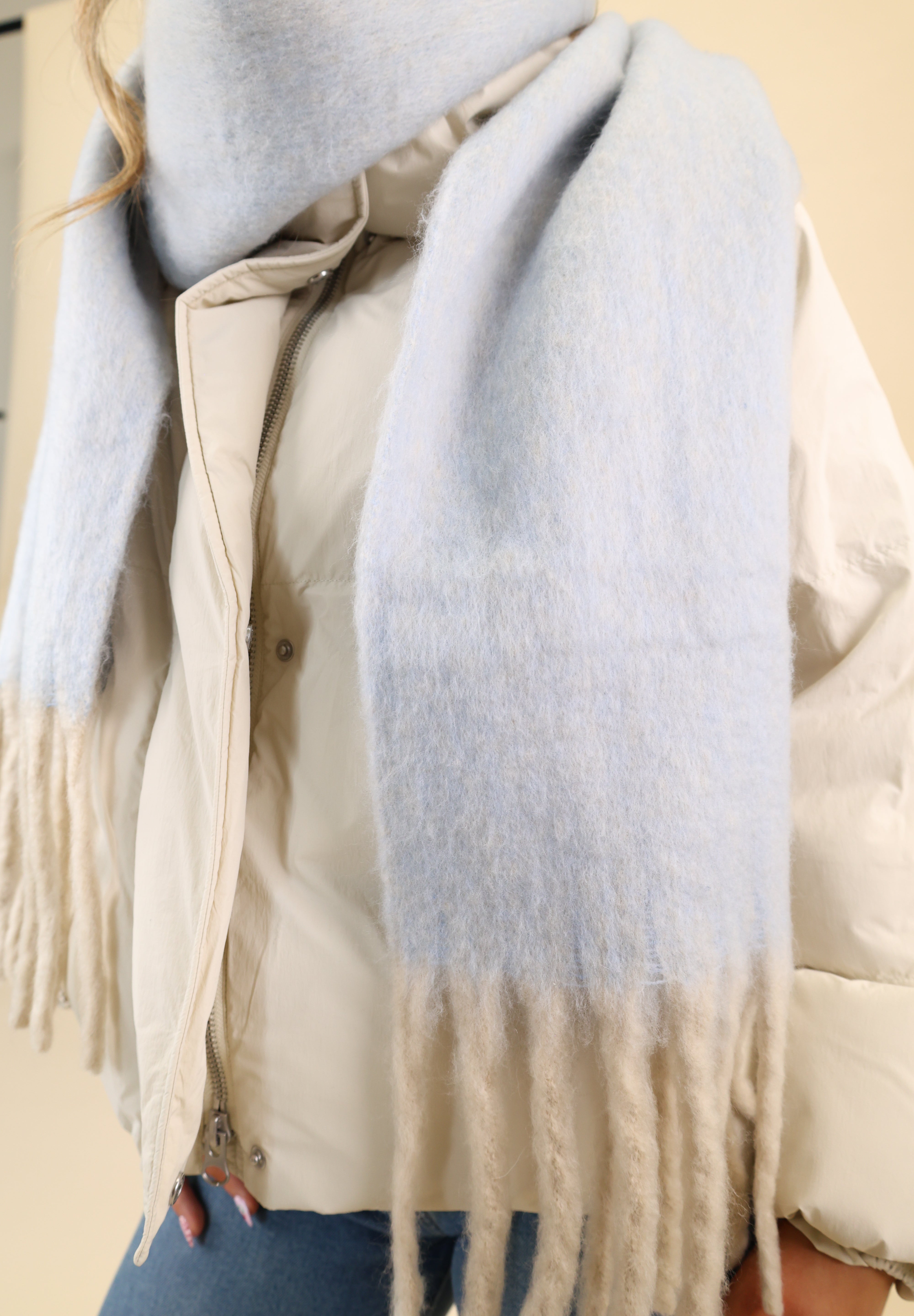 Blue Free People Winter Chill blanket scarf featuring a plush knit feel and contrasting cream fringe trim for added texture.