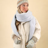 Cozy Free People Winter Chill blanket scarf made from super soft knit fabric in blue, finished with cream fringe detailing.
