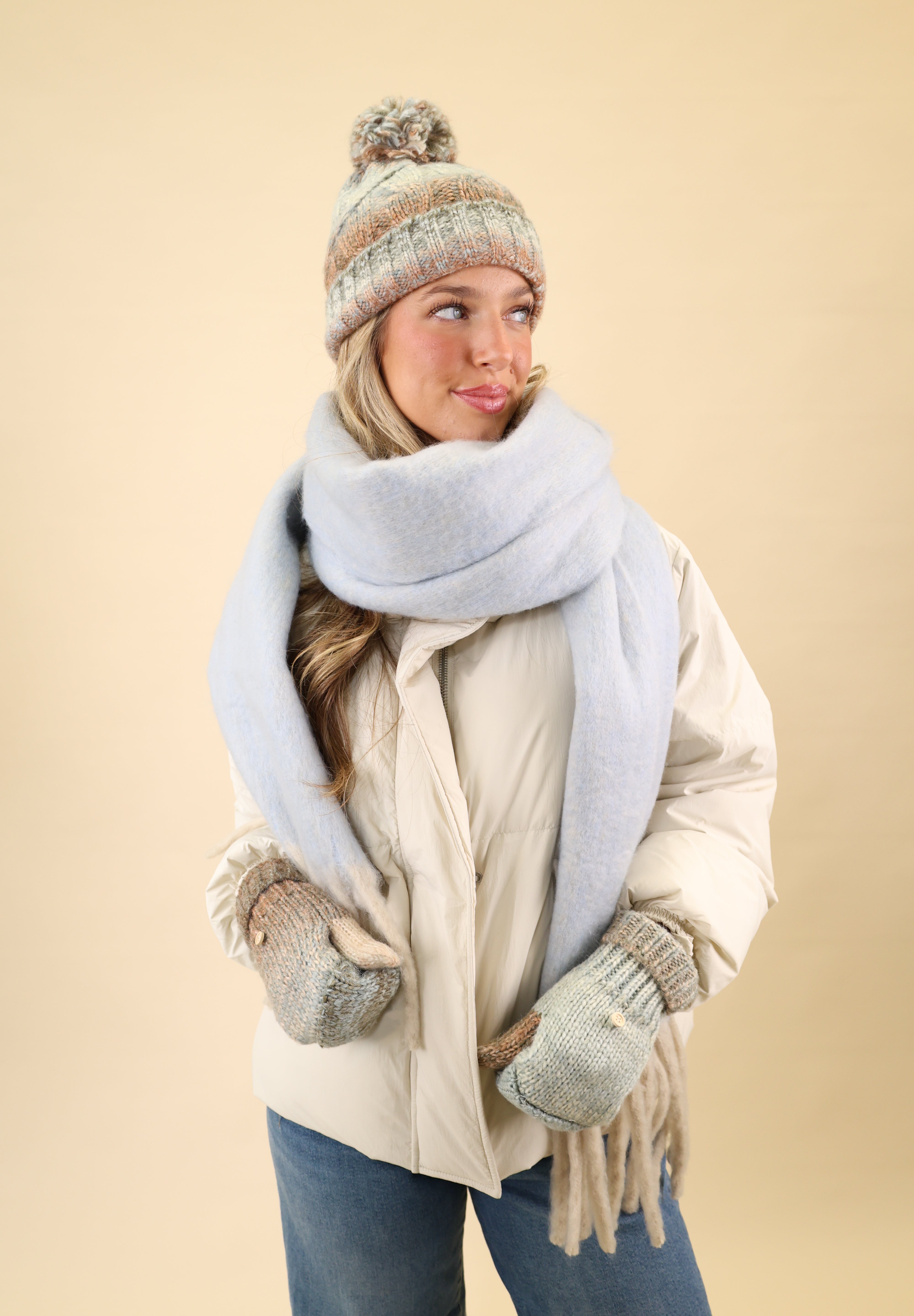 Cozy Free People Winter Chill blanket scarf made from super soft knit fabric in blue, finished with cream fringe detailing.