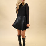 Steve Madden Nevah dress featuring a sleek faux-leather pleated mini skirt, mock neck, and long sleeves.