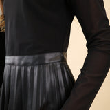 Steve Madden Nevah faux-leather mini dress featuring pleated detailing, a mock neckline, and long sleeves.