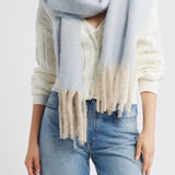 Free People Winter Chill blanket scarf in blue with soft white fringe trim.