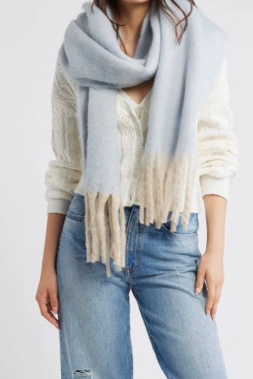 Free People Winter Chill blanket scarf in blue with soft white fringe trim.