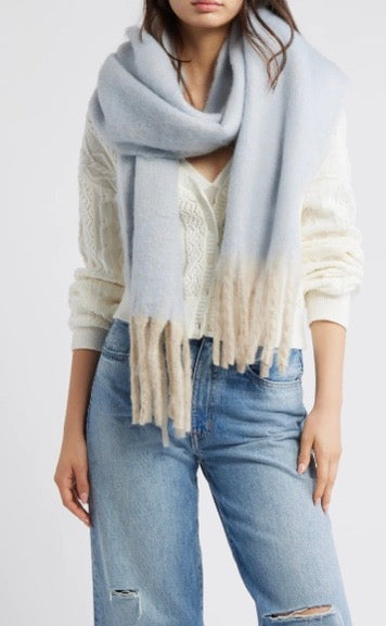 Free People Winter Chill blanket scarf in blue with soft white fringe trim.