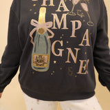 Mid-weight crew-neck sweater with soft brushed fleece and a ‘champagne’ graphic on the front.
