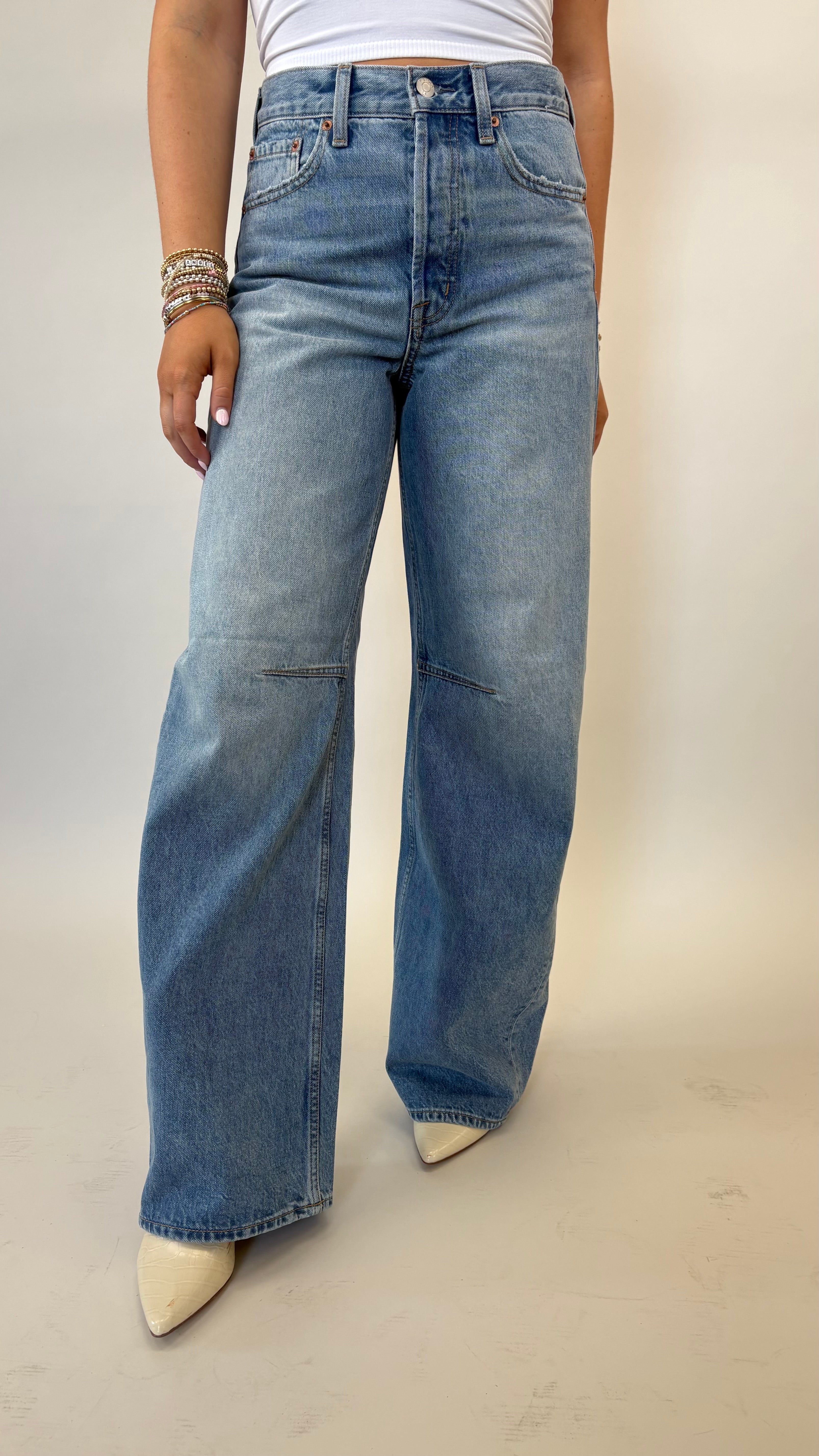 Pistola Sydney high rise jeans with bowed leg silhouette in light wash denim