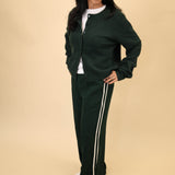 Z Supply Saunder Track Pant in soft green featuring a high-rise silhouette, wide legs, and white seam stripes.