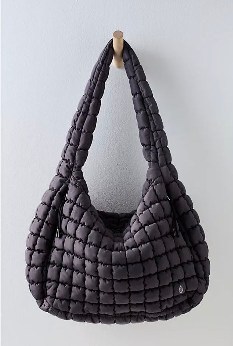 Black Free People quilted carryall tote featuring adjustable shoulder strap, zip-top closure, and front pockets