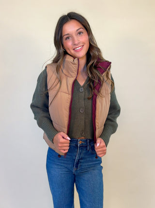 front view of kansas reversible puffer gilet vest. Tan and burgundy, wearing tan on the outside. Women's reversible puffer vest. Shear boutique fall collection