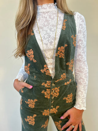 close-up detail shot of green corduroy jumpsuit. shear boutique fall collection