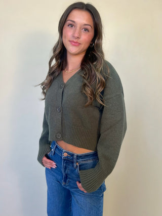 front view of olive green phineas cardigan/sweater. v-neck front button down. shear boutique fall collection  