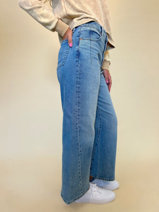 side view of model wearing kyra high rise bowed ankle women's trendy jeans. Pistola - shear boutique jeans fall 