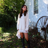 Women’s delicate lace mini dress styled with heels and statement jewelry for a special occasion