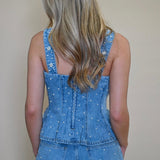back view of Fiorella top showing zipper and pearl embellishment details. Women's peplum denim corset top from Shear Boutique, Maryland 