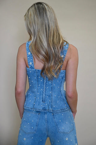 back view of Fiorella top showing zipper and pearl embellishment details. Women's peplum denim corset top from Shear Boutique, Maryland 
