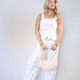 Floral embroidered denim crop top with playful ruffle hem and artisan details