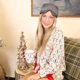 Satin two-piece Nutcracker PJ set from Peach Love, featuring a long-sleeve top and matching shorts adorned with gingerbread and bows.